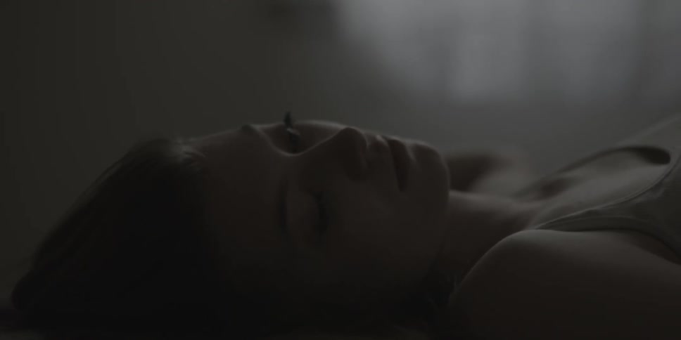 A young woman lying flat on her back
