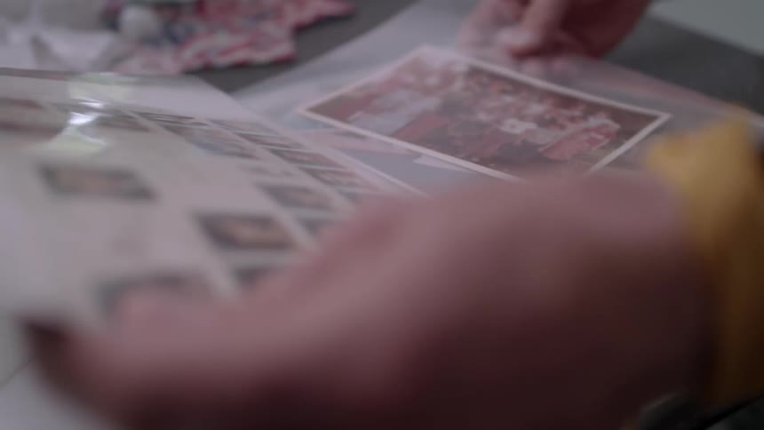 A person flips through a photo album