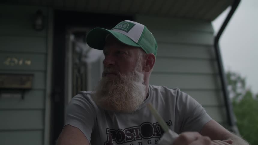A man sits on his front step