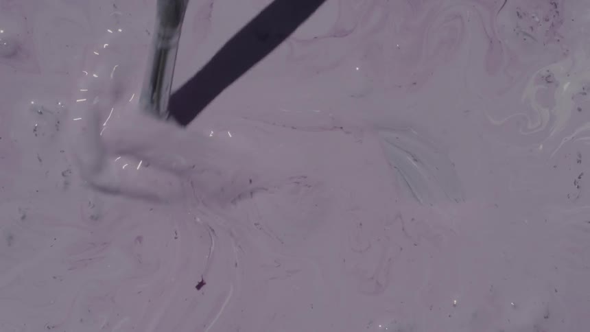 A person is mixing paint