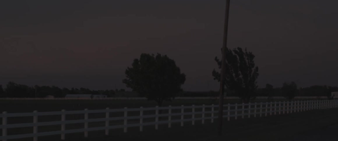 A white picket fence lines the field