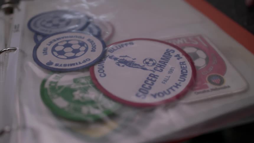 A selection of soccer patches are in a pouch in a binder