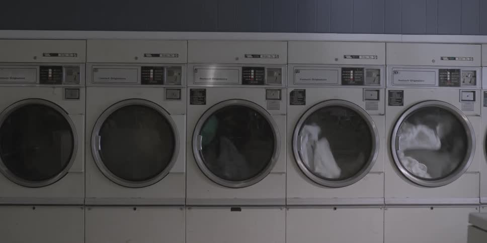 Clothes spin in the dryers of a laundromat