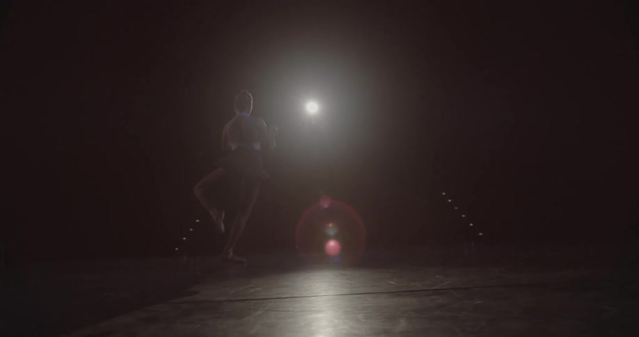 A ballerina is performing onstage