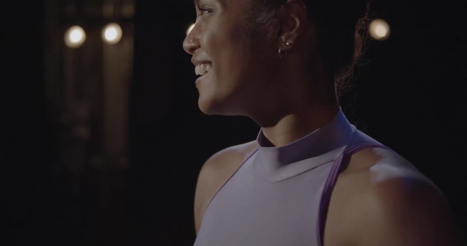 Woman in a purple dress smiles and laughs