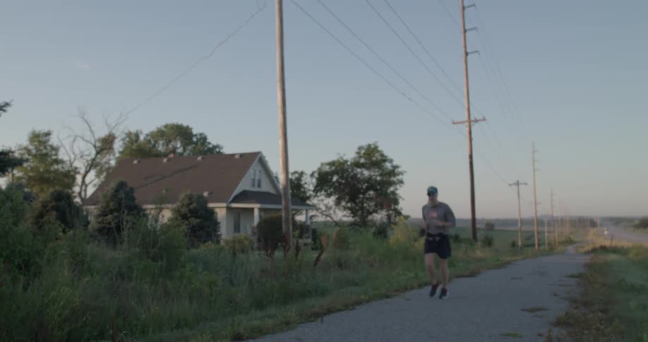 A man jogs down the path by the home