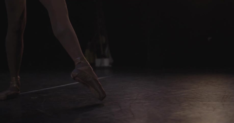 A ballerina dances on pointed toes