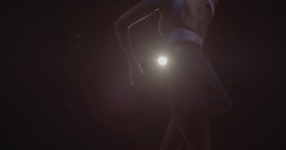 A woman is dancing on the stage jumping