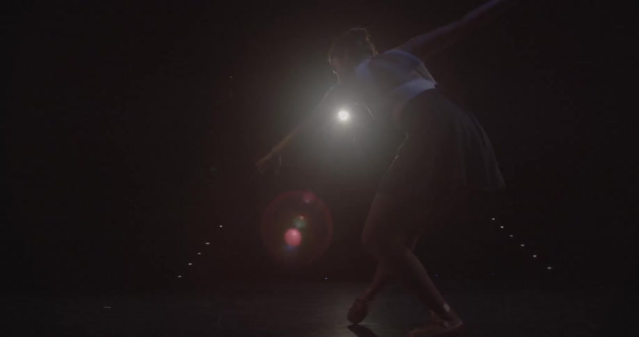 A ballerina is performing onstage