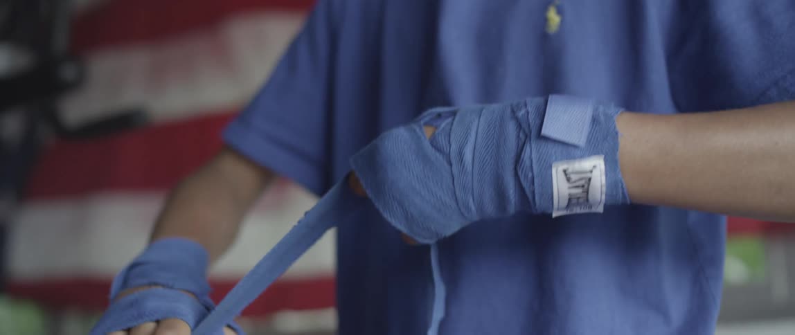 Man wrapping his hands with athletic tape