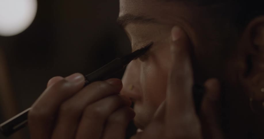 A woman is applying makeup