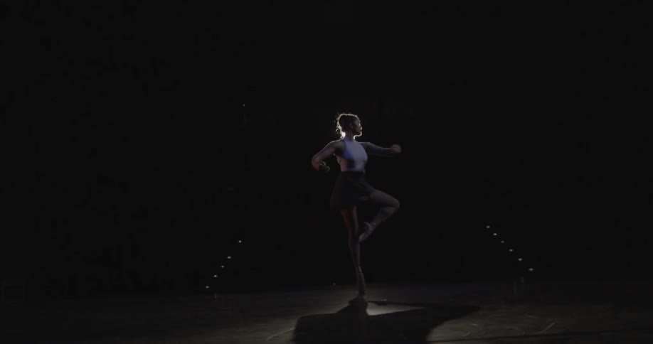 A ballerina dances on stage