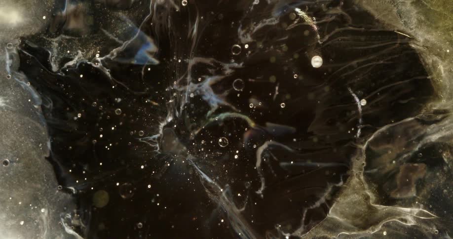An abstract cosmic background of glittering particles and swirling clouds of gas against a dark canvas