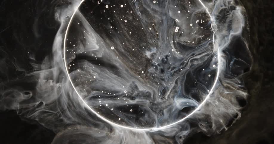 A mesmerizing abstract visual of swirling white and black fluid art resembling a celestial nebula with a glowing ring