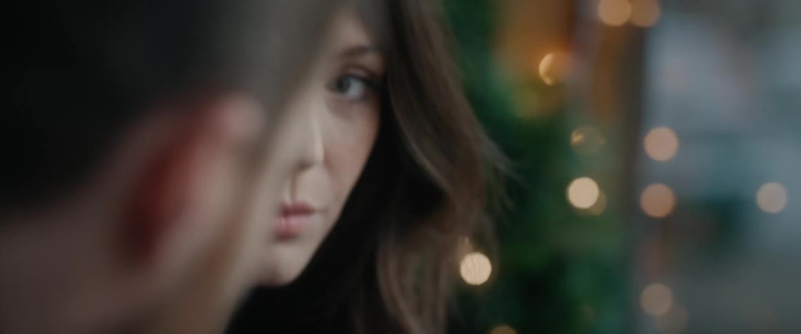A poignant close-up shows a woman shedding a single tear during an emotional moment