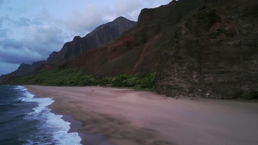 Ocean waves wash ashore a sandy beach