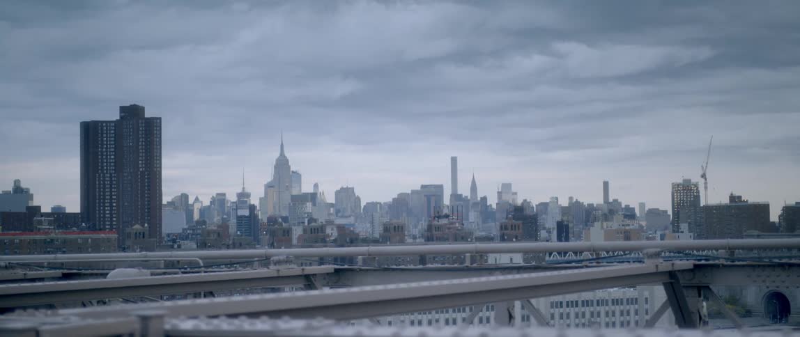 City buildings and skyscrapers are shown on a cloudy day