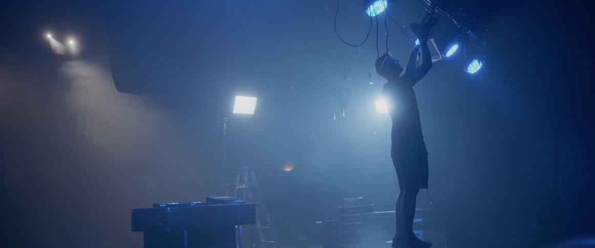 A man adjusts spotlights