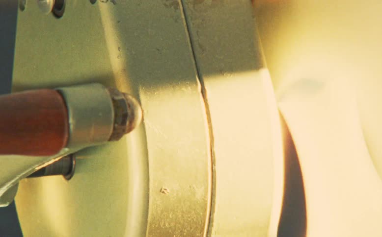Close-up detail shot of an old movie projector with reels spinning, evoking a retro and nostalgic feeling