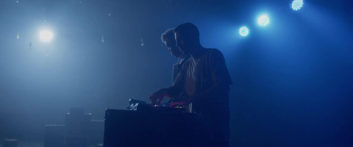 Two djs playing in a nightclub