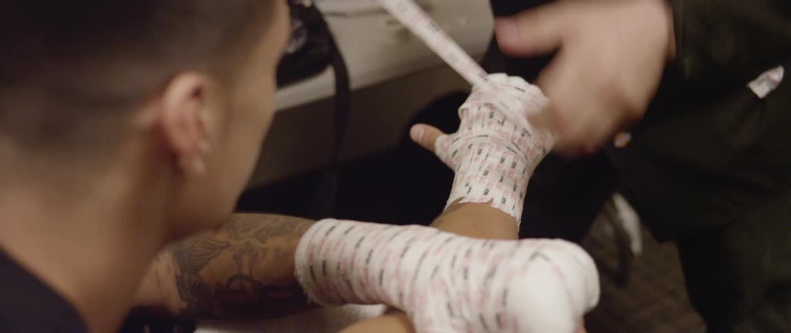 Man having his hands wrapped with athletic tape