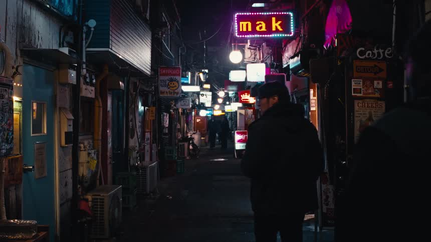 Two men walk down a narrow, dark city alleyway at night, illuminated by a vibrant collection of glowing neon signs