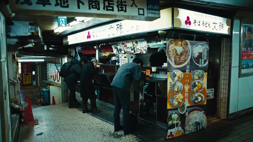 Men eat at a traditional noodle bar in a gritty underground market in Japan