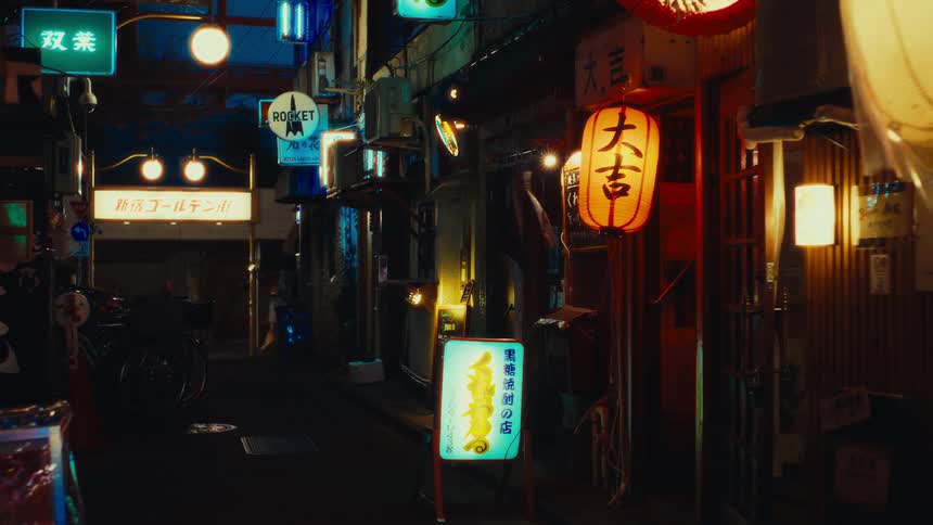 Glowing paper lanterns and neon signs illuminate a moody back alley in a Japanese city as a lone figure walks away at night