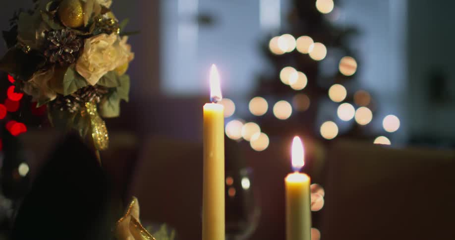 Candles lit on top of the dining room table