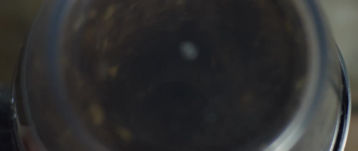 Coffee beans whirl in a grinder