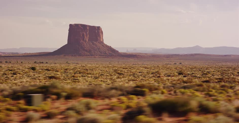 A scenic drive through the iconic Monument Valley reveals majestic red rock buttes across the vast desert landscape