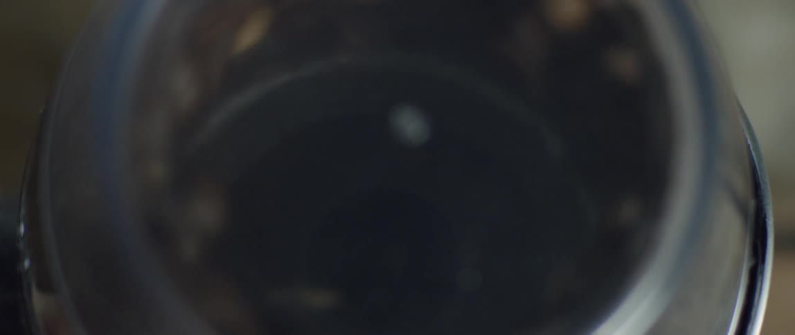 Close up of coffee beans spinning around in a machine