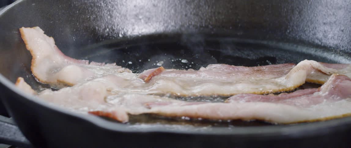 Bacon sizzling in a frying pan