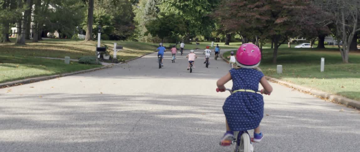 Children ride their bicycles on a residential street