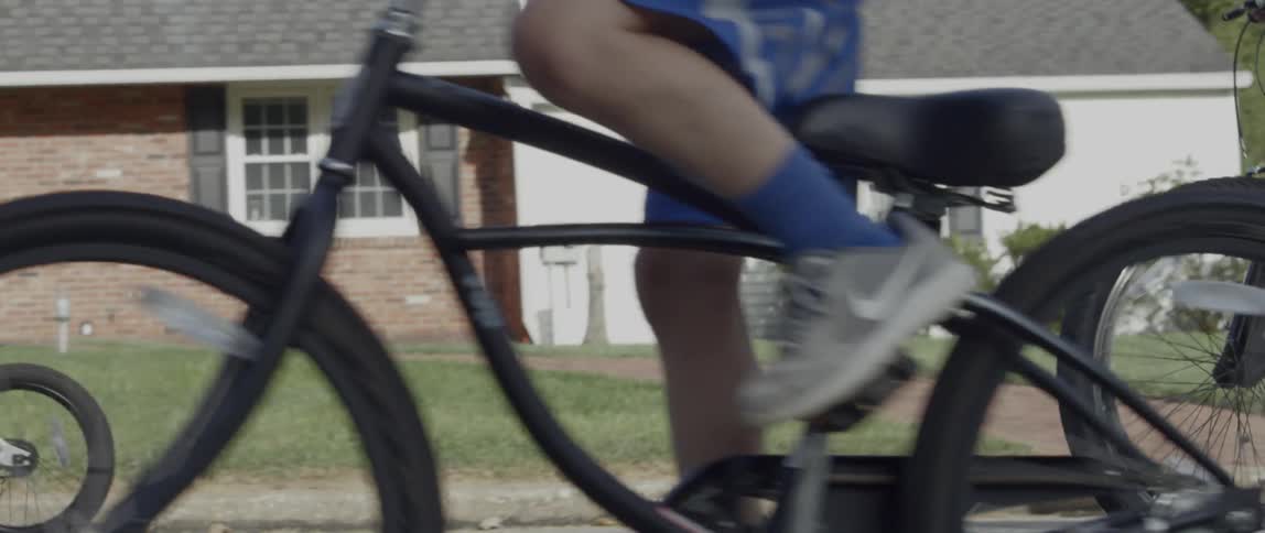 Group of children ride bikes in the street