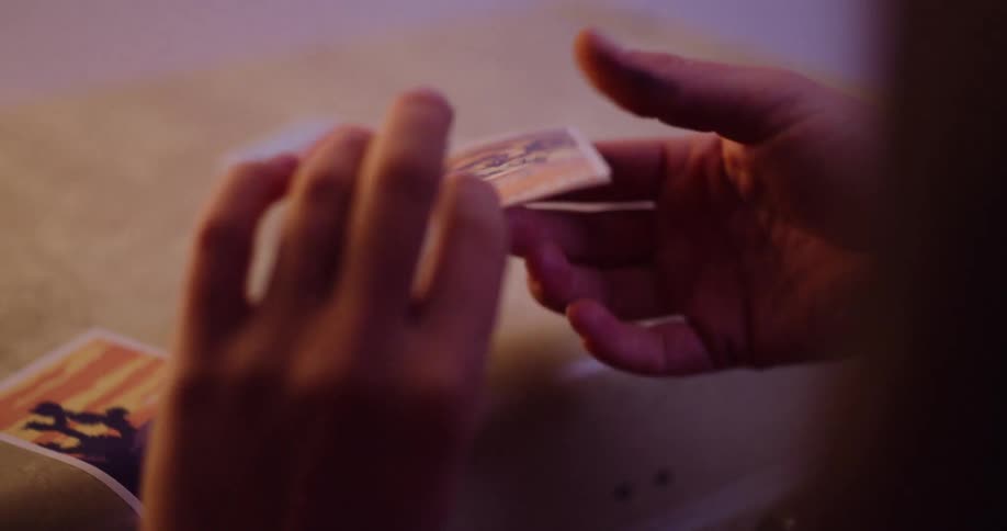 A person's hands carefully unfold a Death Valley sticker and place it onto a surface with other travel stickers