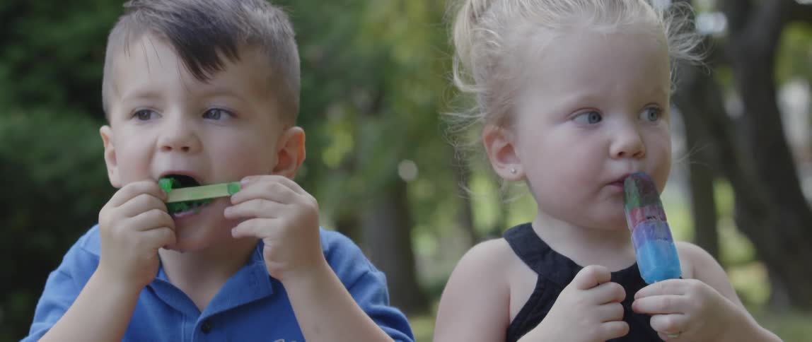Two children eat some ice cream together