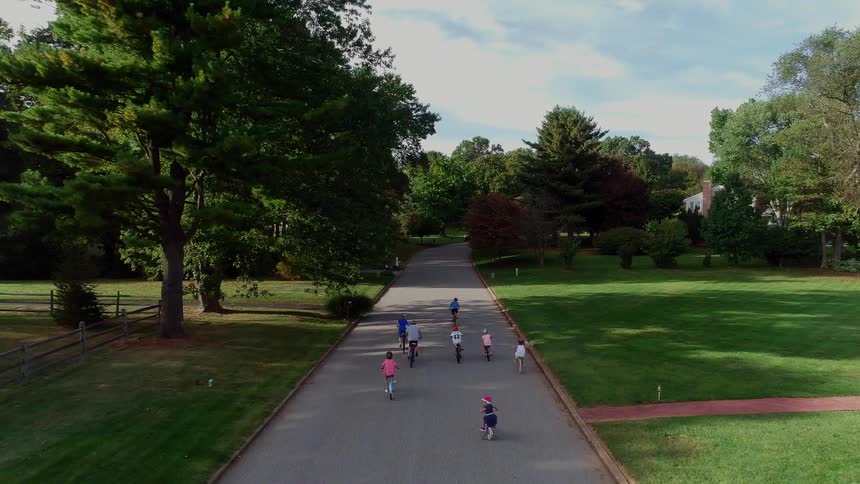 A herd of kids bikes down the road