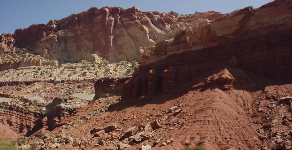 A smooth dolly shot of the vibrant red rock formations and arid landscape of Capitol Reef National Park, Utah