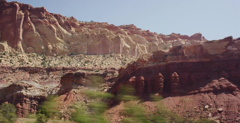 A slow-motion drive-by shot reveals the majestic and colorful red rock formations of Capitol Reef National Park in Utah