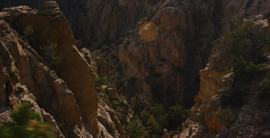 A cinematic slow pan reveals the majestic and rugged landscape of a vast mountain canyon