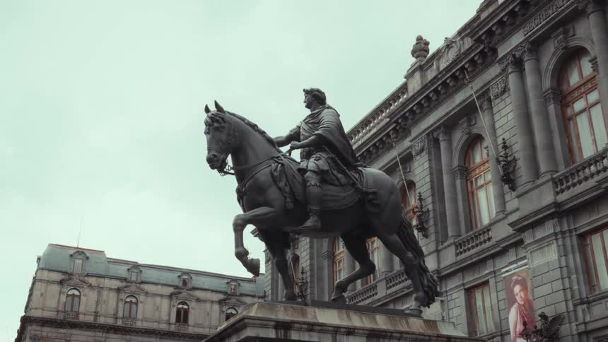 Slow zoom shot of the majestic Equestrian Statue of Charles IV outside the National Museum of Art in Mexico City on a cloudy day