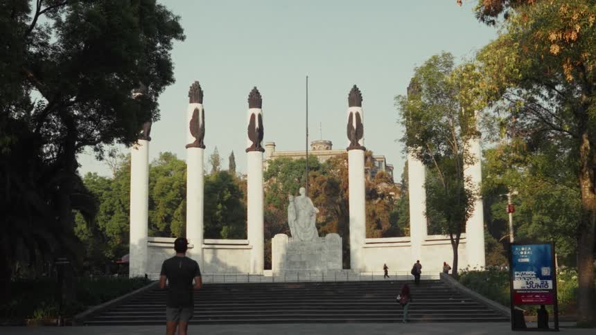 A man begins his morning run towards the iconic Monumento a los Niños Héroes in Mexico City's Chapultepec Park