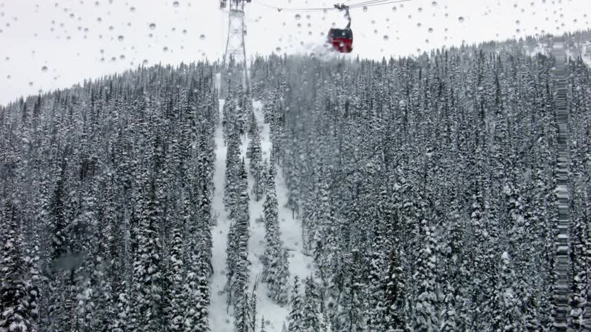Ski lift travels up a snowy mountain
