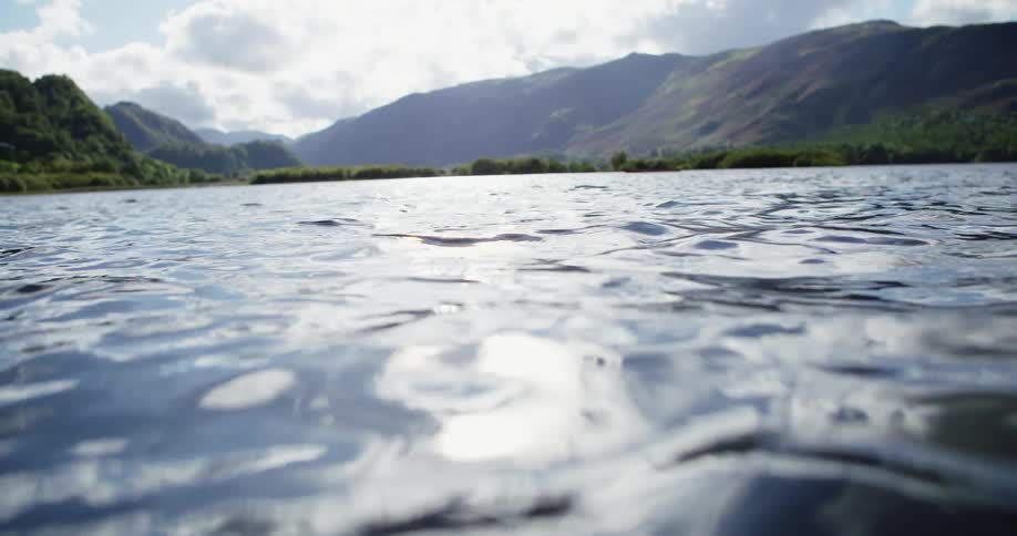 Rippling water in a lake in the mountains on cloudy day
