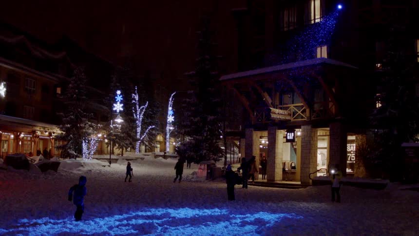 Children play running around a square at night