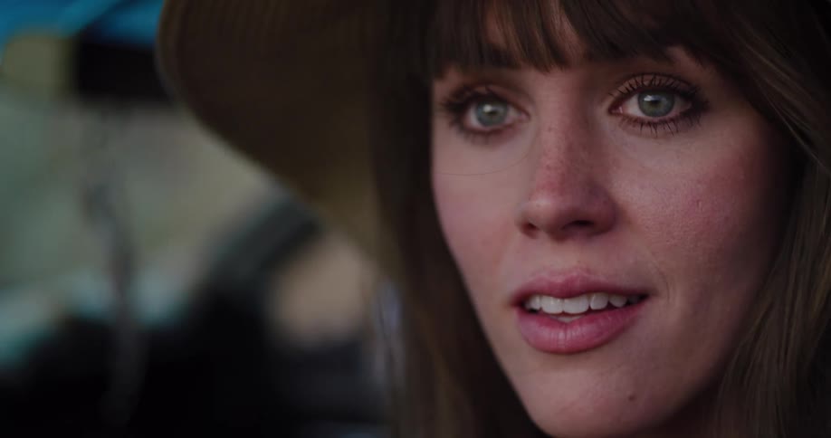 A cinematic close-up of a beautiful young woman in a straw hat turning her head to look at the camera with wide-eyed wonder