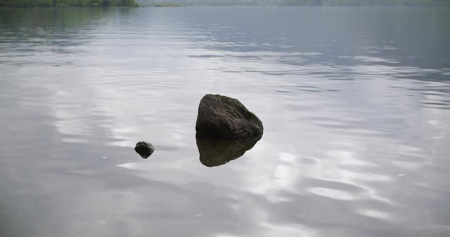 A rock is floating in the calm water