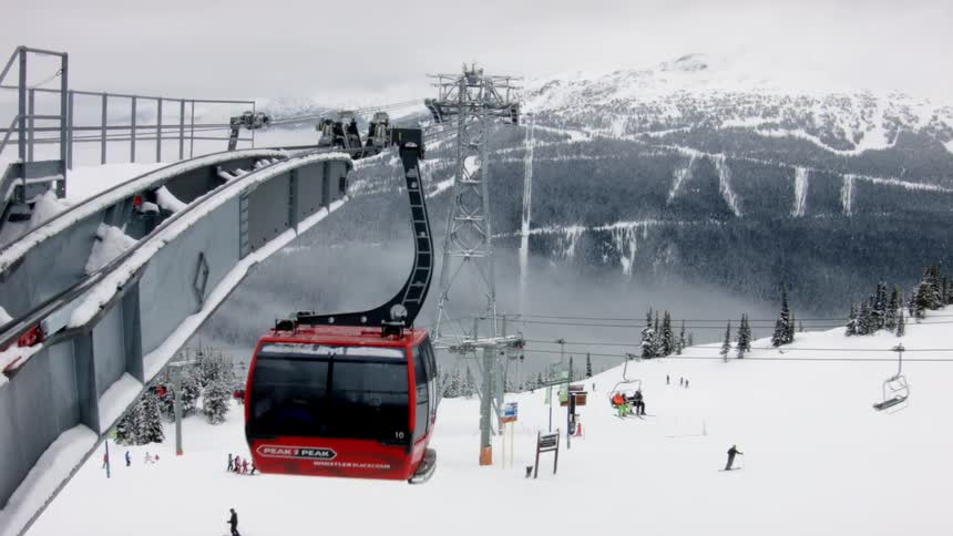 People riding on gondola lifts at snow ski park resort