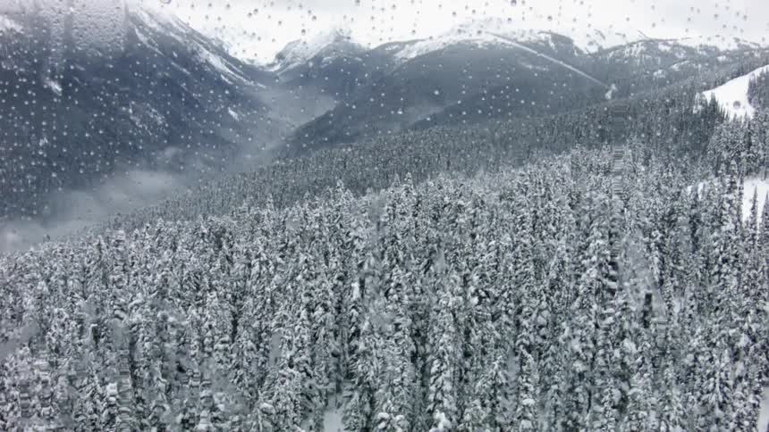 A lift travels up the side of a snowy mountain